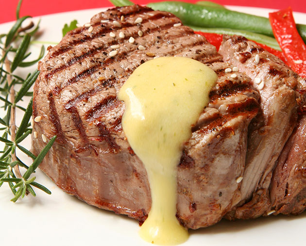 perfectly cooked steak with a drizzle of béarnise sauce